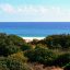 La spiaggia del Villaggio Marina Rey a Costa Rei circondata dalla fitta vegetazione mediterranea